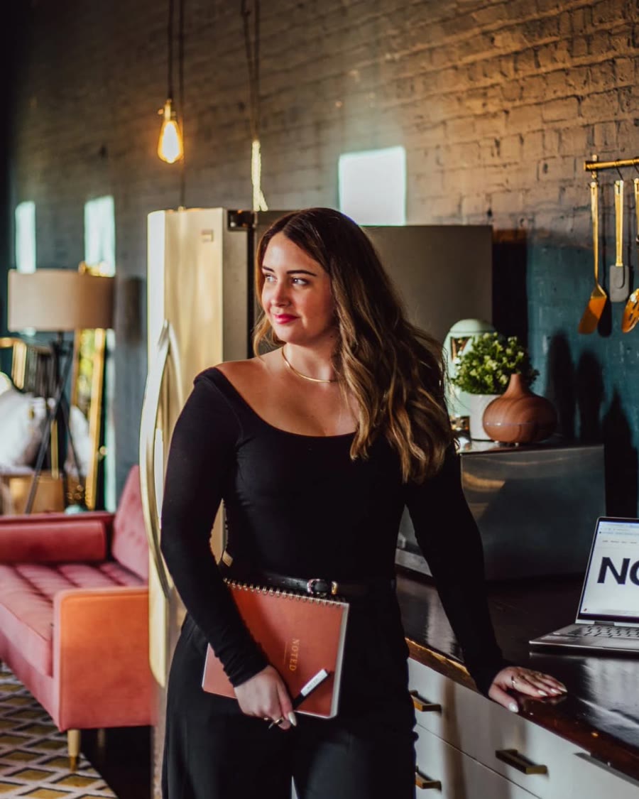 Allison Chavis, Marketing and Events Assistant at Stem & Vine and founder of Noted., in a plant-filled Baltimore studio