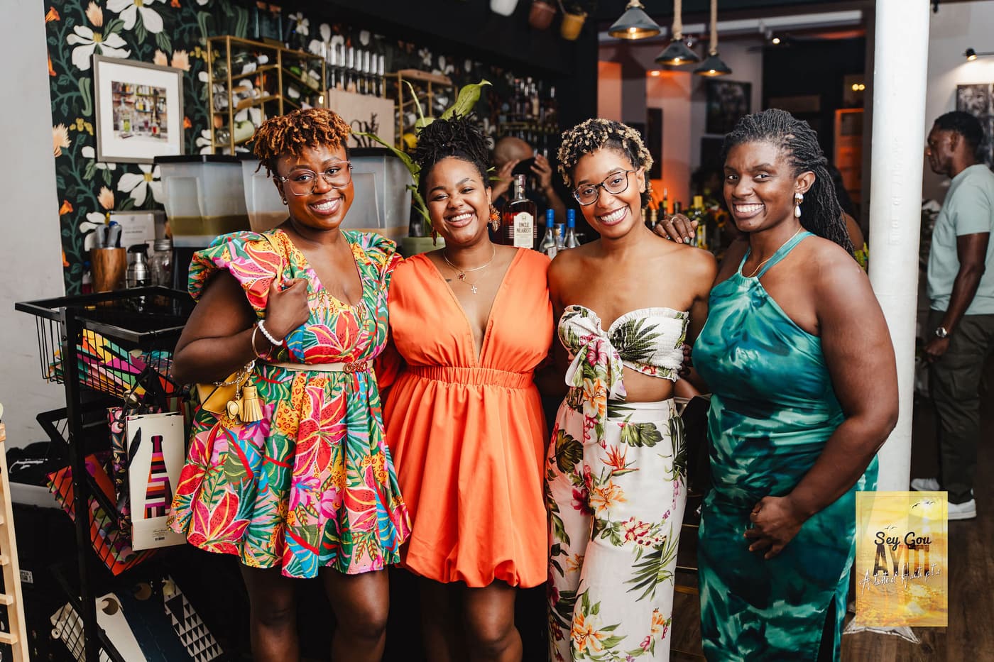 Four guests smiling together at an event at Stem & Vine