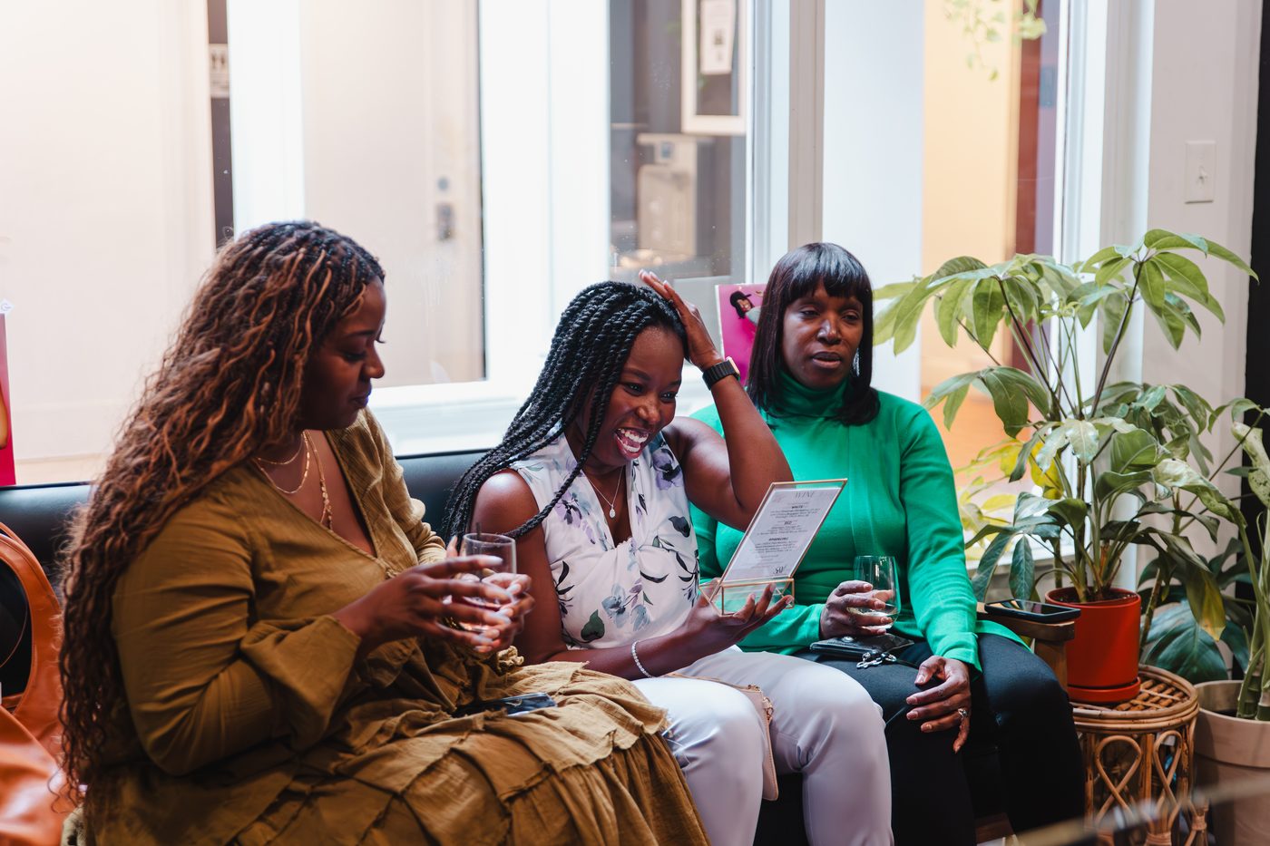 Guests reading notes together on the couch during a bridal shower at Stem & Vine in Baltimore