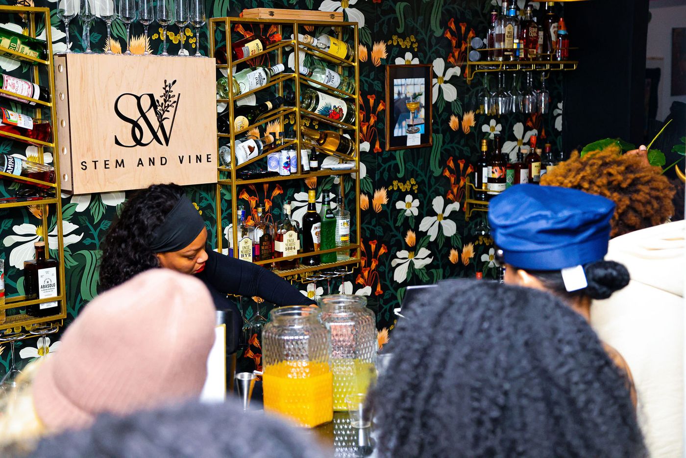 Guests gathered at the Botany Bar beneath the Stem & Vine sign during a Halloween party in Baltimore