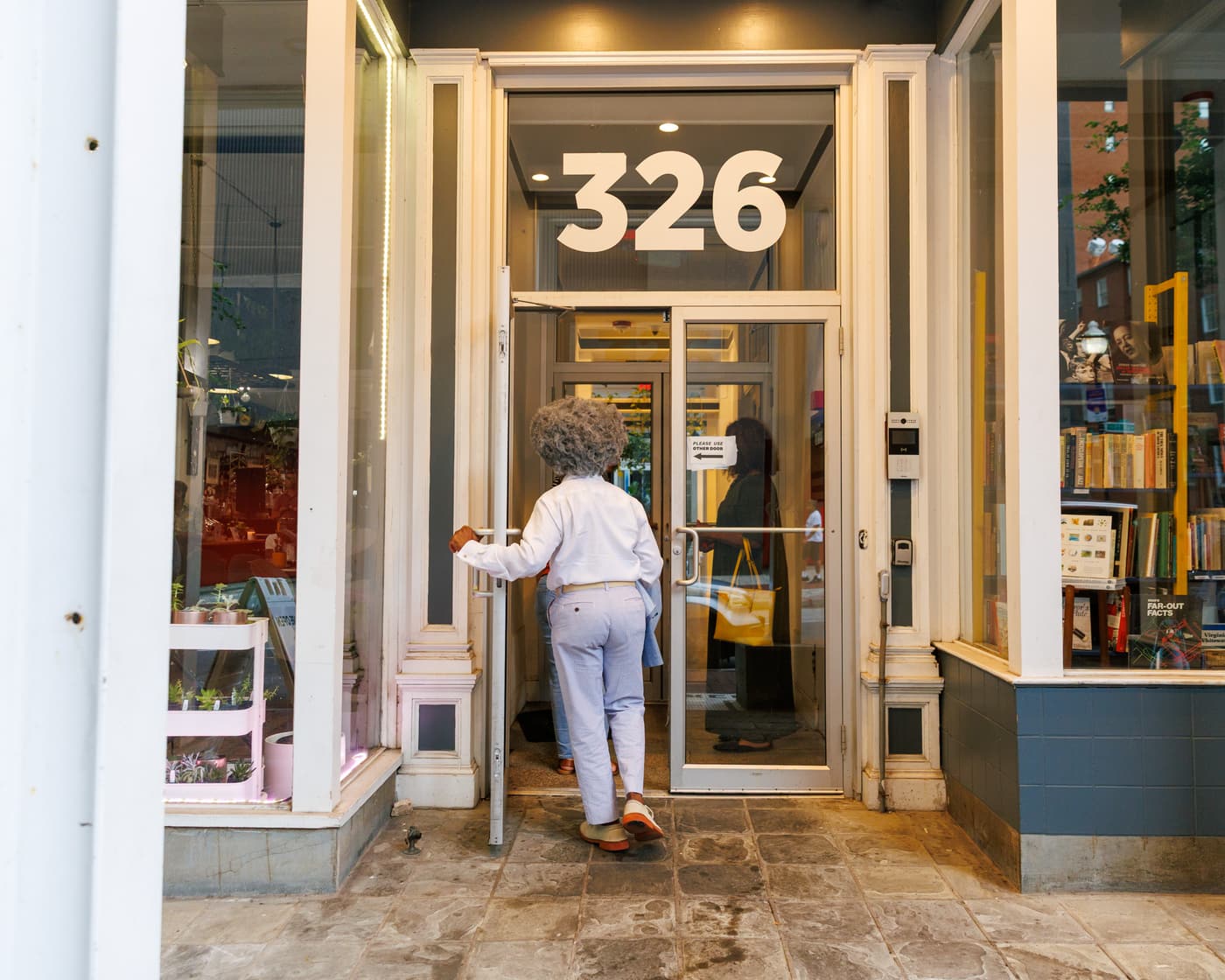 A customer stepping through the 326 North Charles Street doorway into Stem & Vine in Baltimore