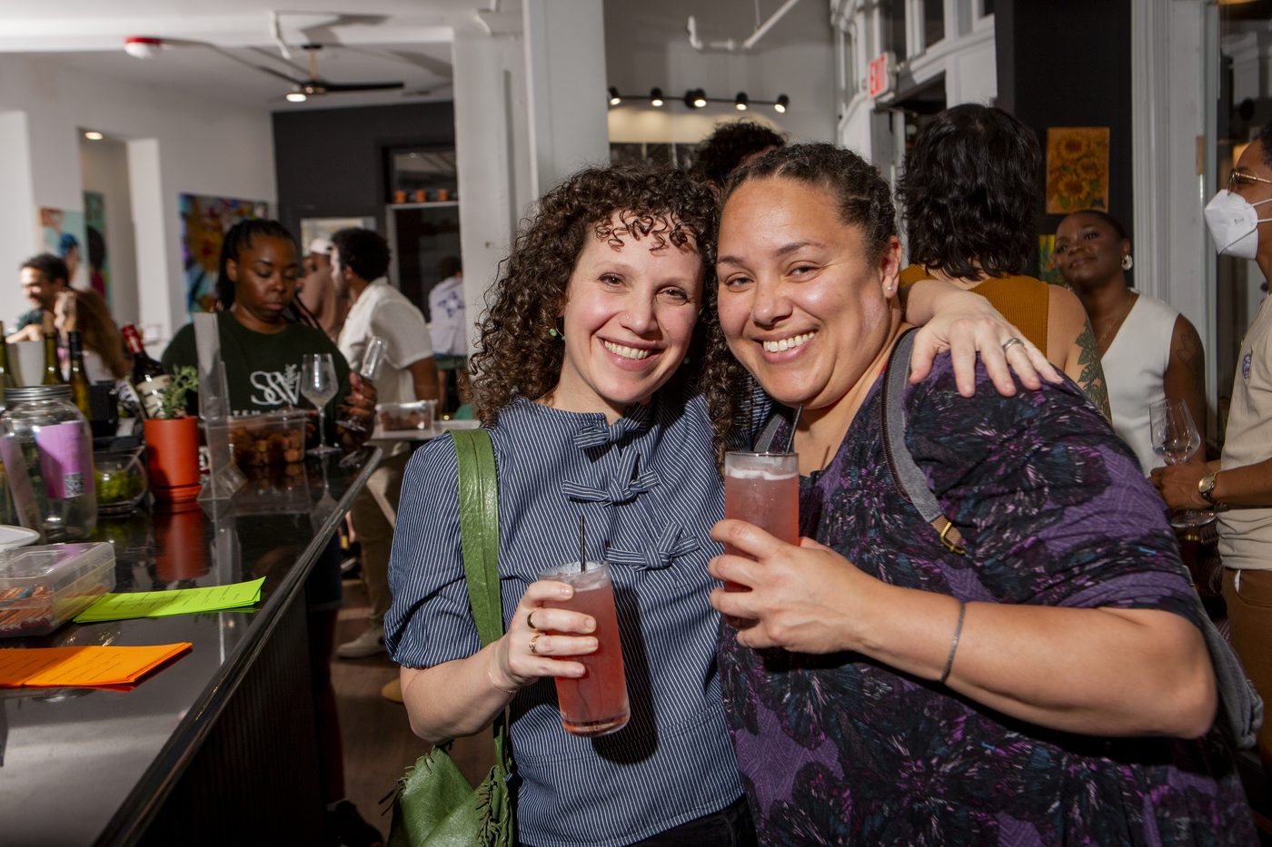 Guests talking over drinks during a mixer in the Gallery at Stem & Vine in Baltimore