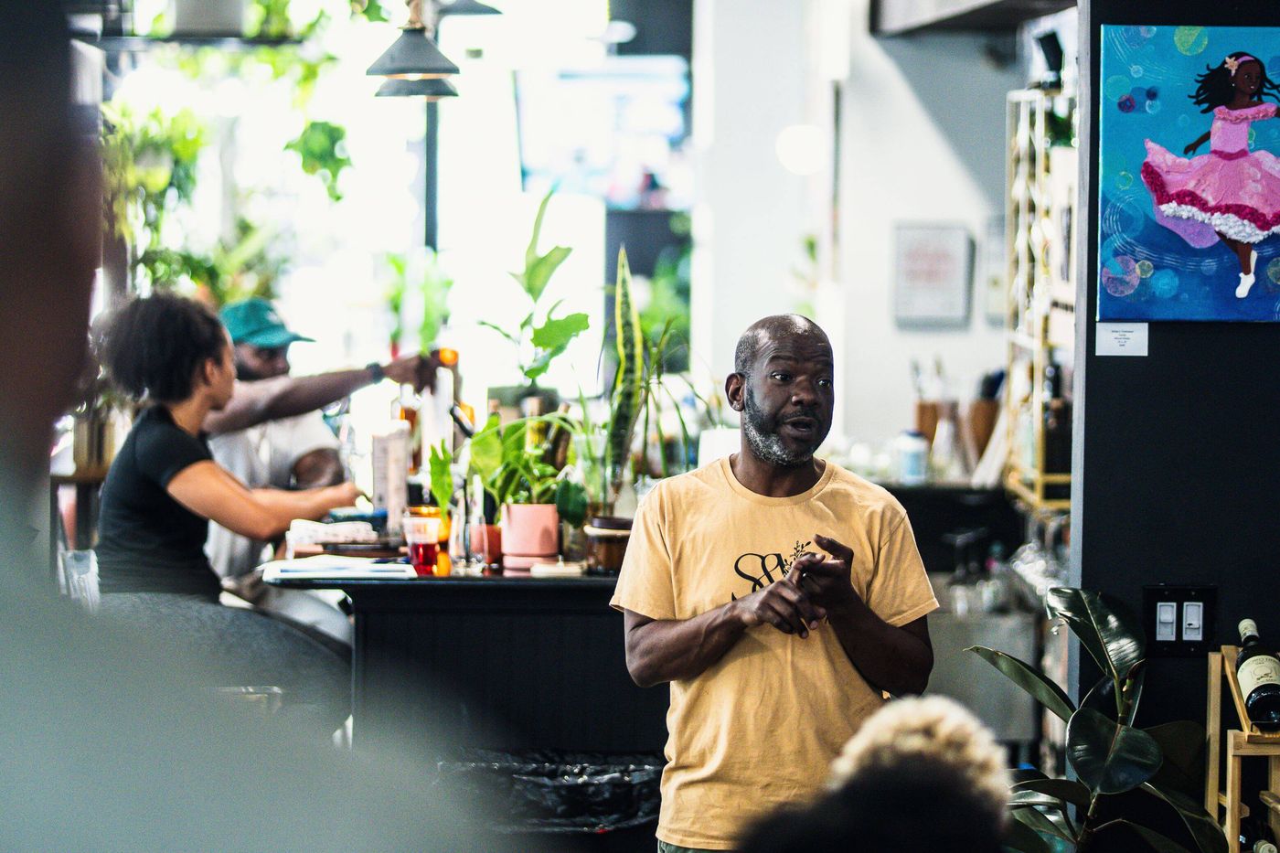 Bartender pouring at the plant-lined Botany Bar at Stem & Vine in Baltimore