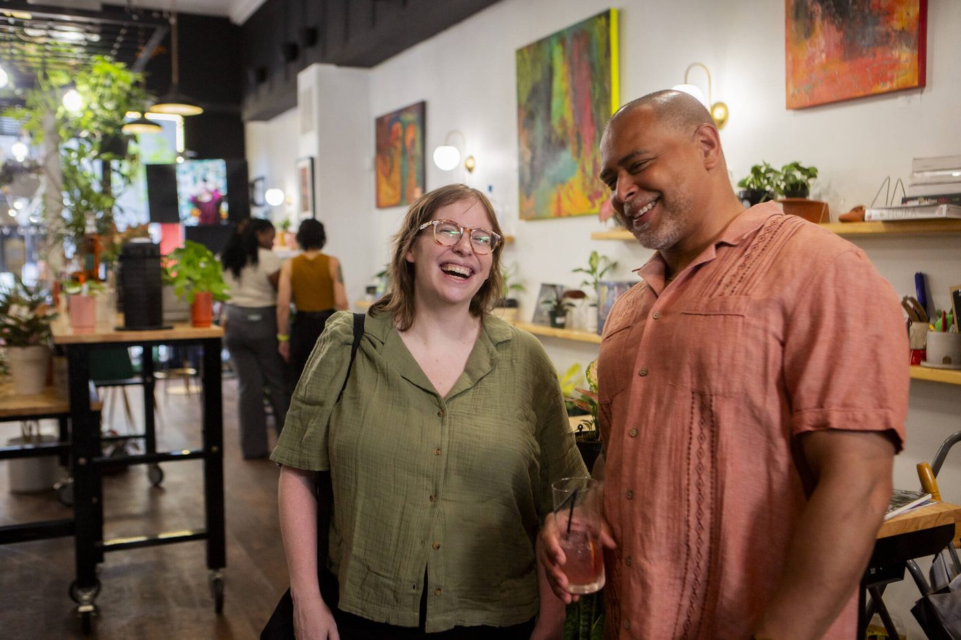 Two guests laughing together at a private celebration at Stem & Vine, Baltimore