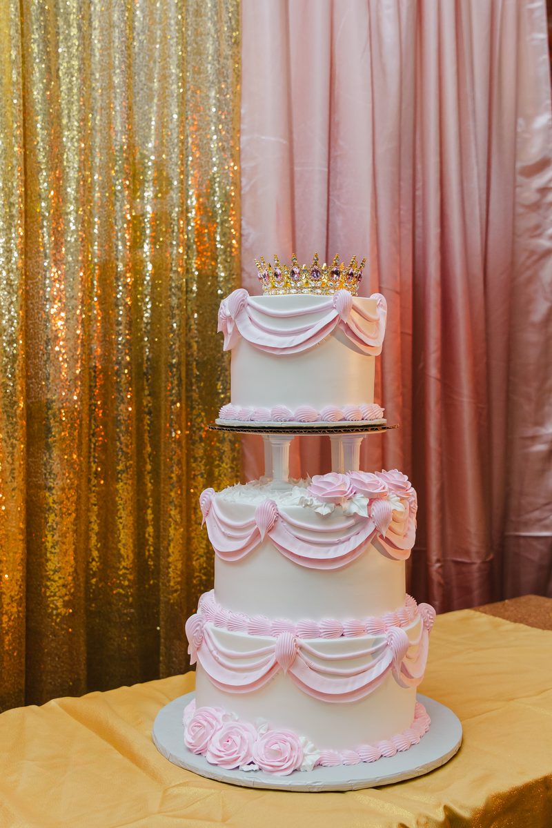 A three-tier quinceanera cake against gold sequins at Stem & Vine, Baltimore