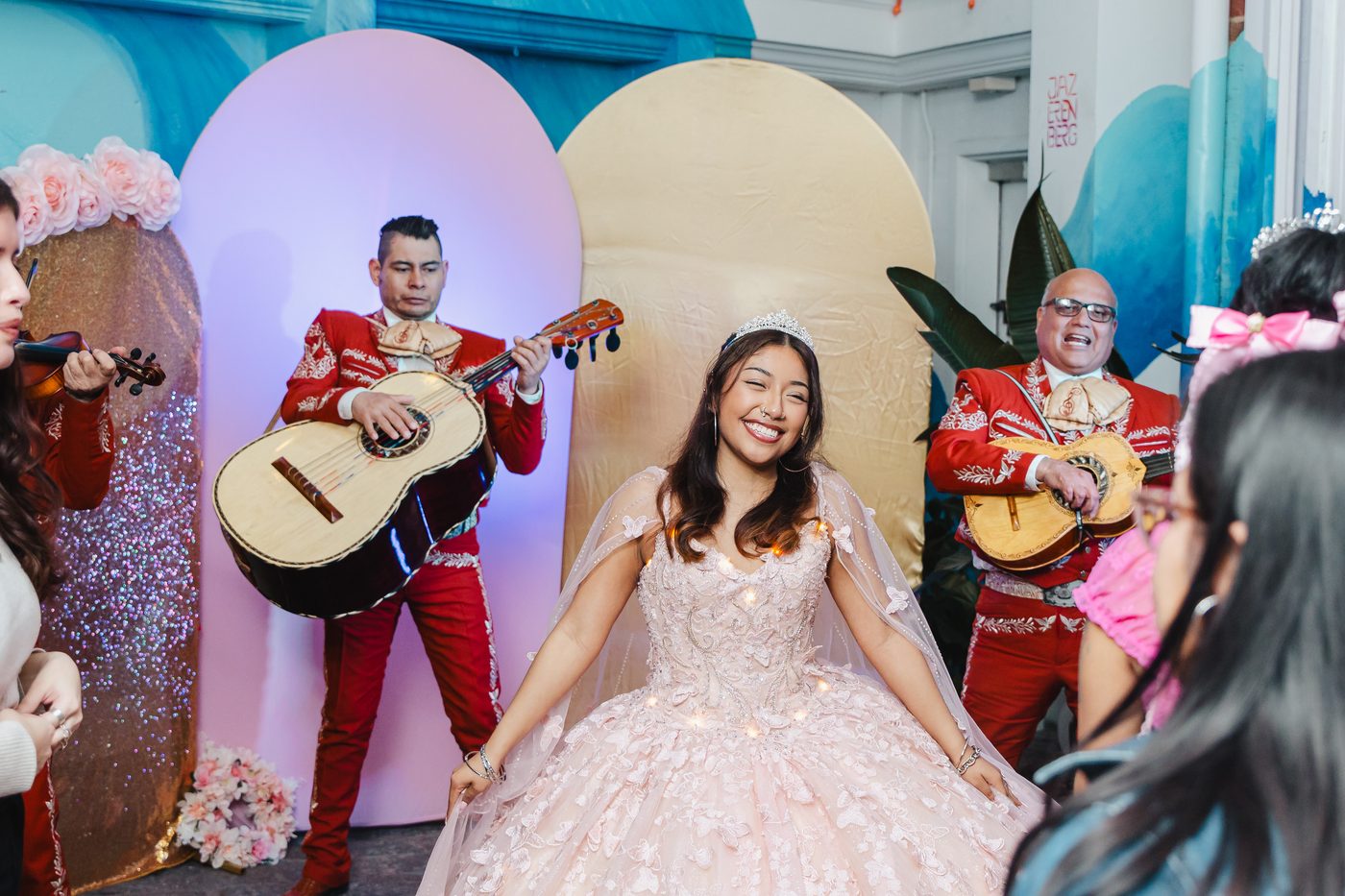 A quinceanera in her ballgown dancing as a mariachi trio plays in the courtyard at Stem & Vine, Baltimore