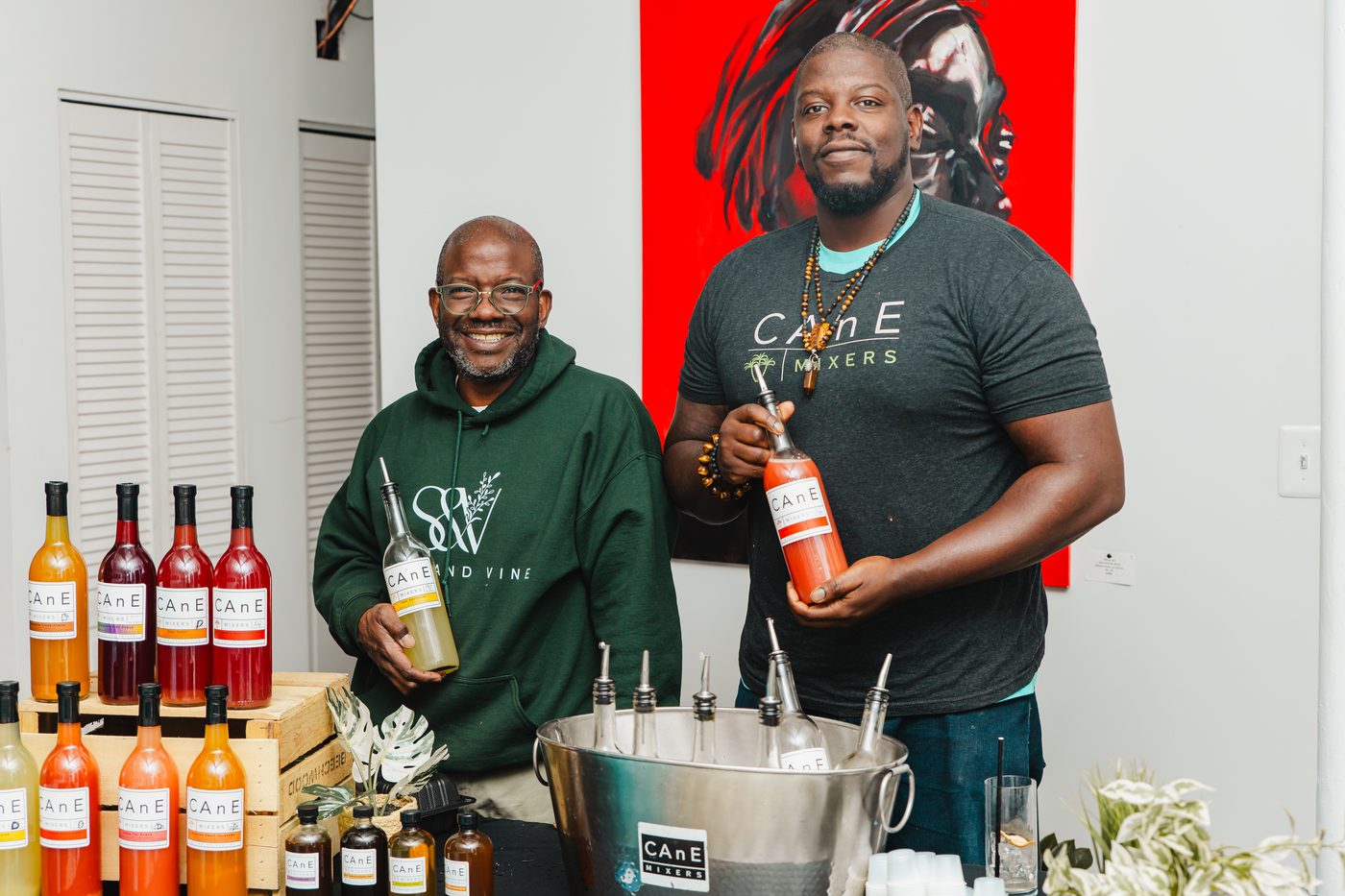 The Stem & Vine and CAnE Mixers founders behind a table of CAnE bottles at Stem & Vine in Baltimore