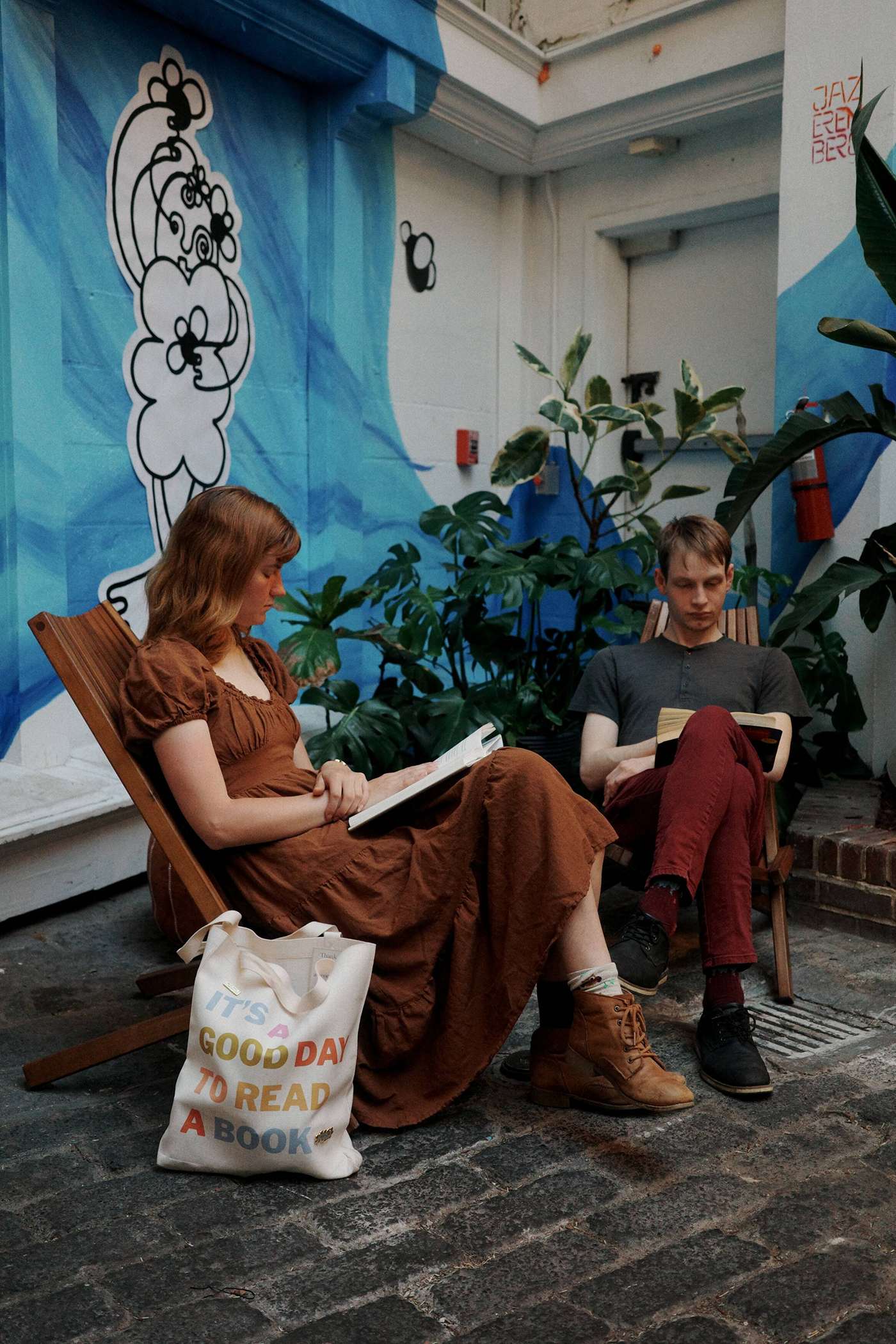 Guest reading beside potted plants at Stem & Vine in downtown Baltimore
