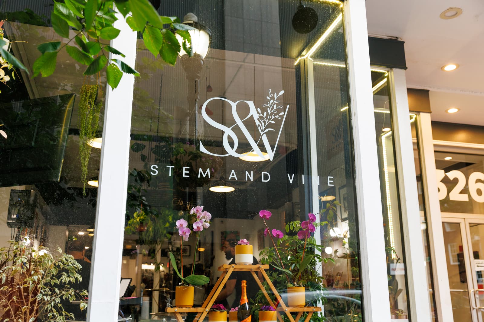 The Stem & Vine window and logo on Charles Street, with the 326 street number beside it