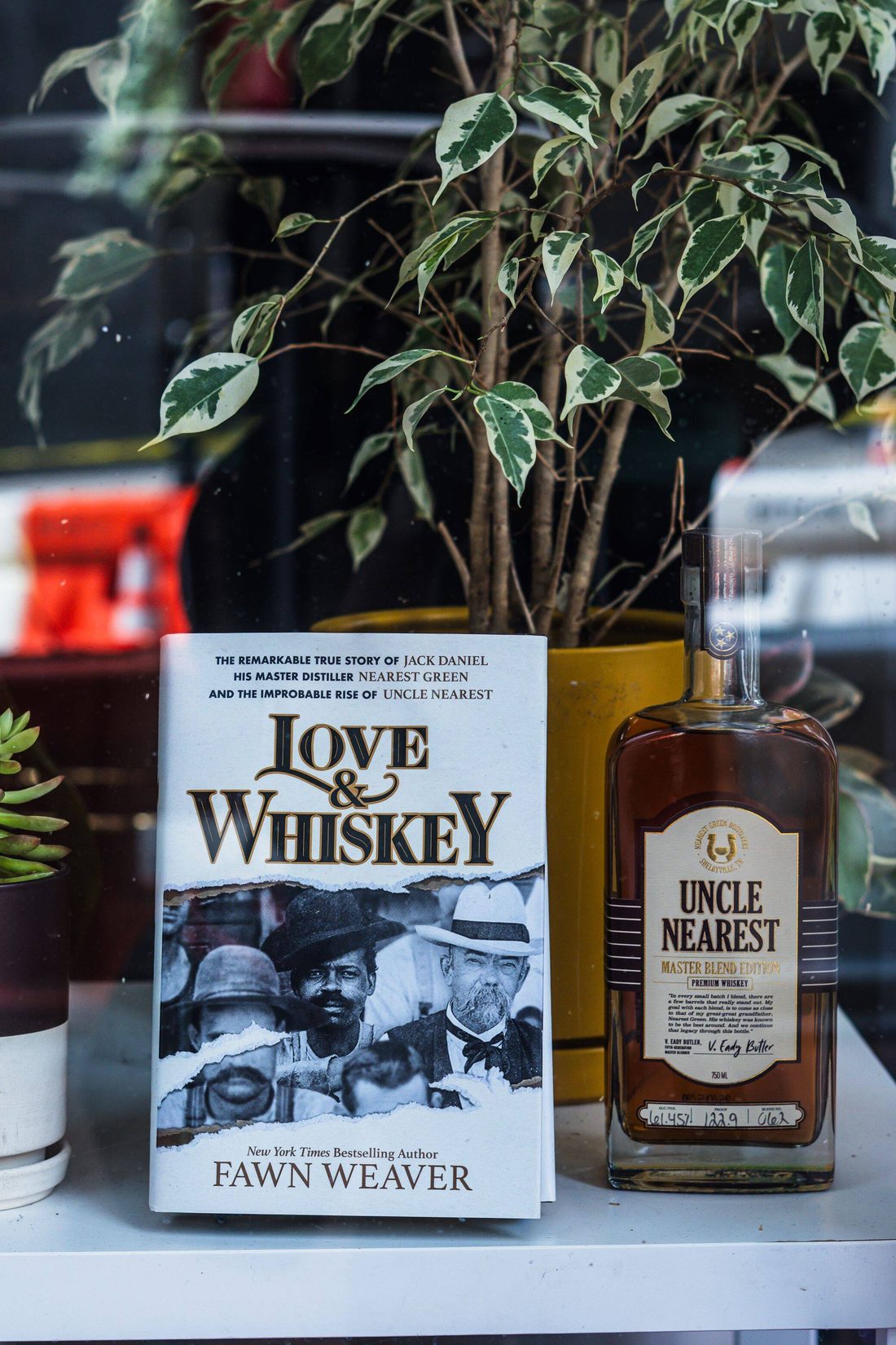 Uncle Nearest whiskey bottle beside the Love and Whiskey book at Stem & Vine, Baltimore