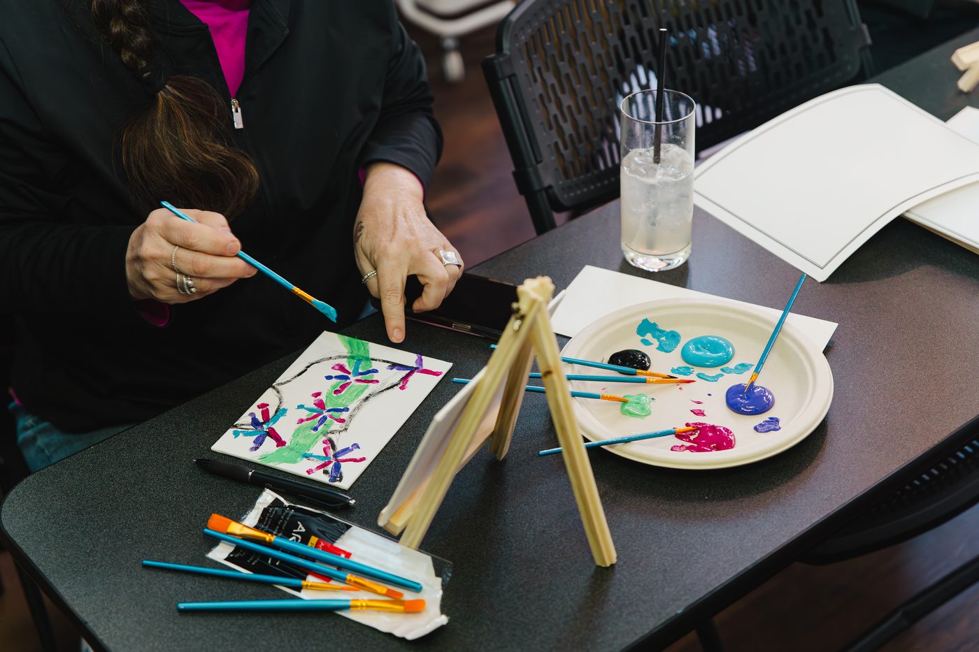 A guest mixing paint at a workshop table at Stem & Vine in Baltimore